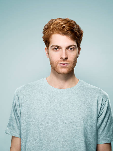 portrait of a re hair male looking into camera - hairstyle stock pictures, royalty-free photos & images