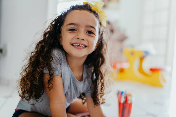 portrait of a smiling little girl at home - hairstyle stock pictures, royalty-free photos & images