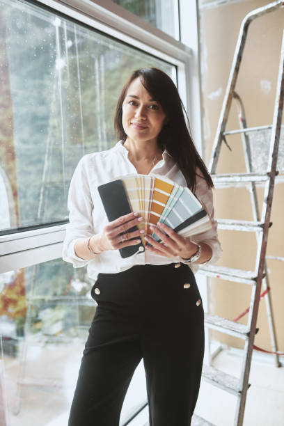 portrait of a woman designer with color palettes - home decoration stockfoto's en -beelden