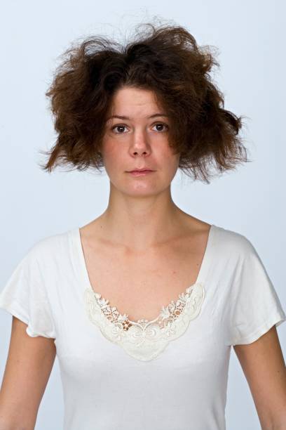 portrait of a woman with messy hair. - hairstyle stock pictures, royalty-free photos & images