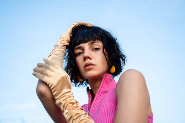 portrait of a young beautiful freckled woman wearing gold satin gloves, fashion and retro style concept. - fashion stock pictures, royalty-free photos & images