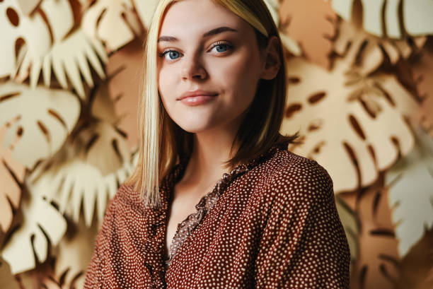 portrait of a young girl on a background with palm leaves. tropical background. portrait of a woman. - fashion stock pictures, royalty-free photos & images