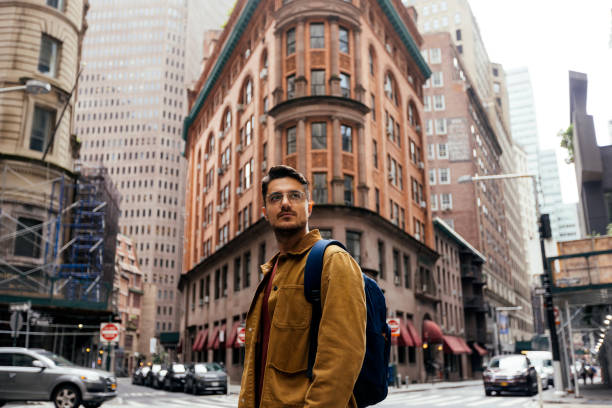 portrait of a young man in eyeglasses on the street in new york city, usa - travel stock pictures, royalty-free photos & images