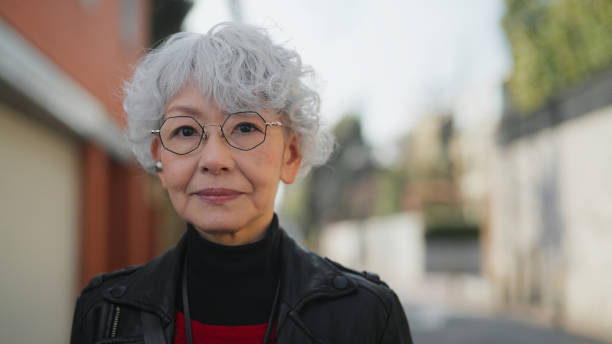 portrait of beautiful and confident asian senior woman in city - fashion stock pictures, royalty-free photos & images