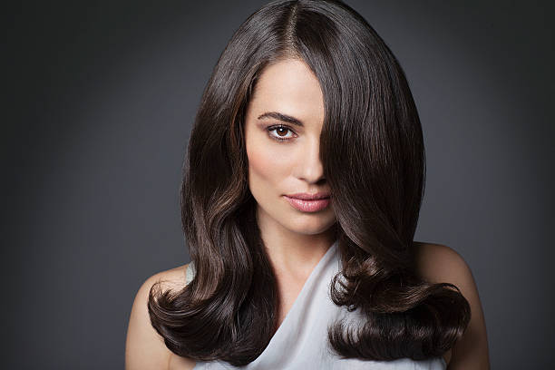 portrait of beautiful woman with long brunette hair - hairstyle stockfoto's en -beelden