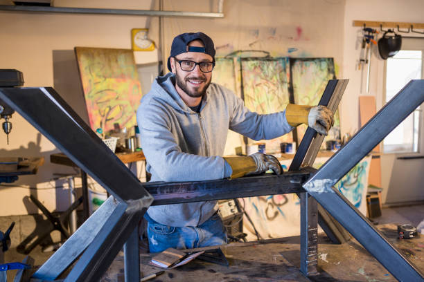 portrait of caucasian man leaning on metal sculpture - home decoration stock pictures, royalty-free photos & images