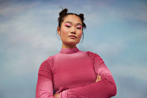 portrait of confident teenage girl with arms crossed against colored background - hairstyle stock pictures, royalty-free photos & images