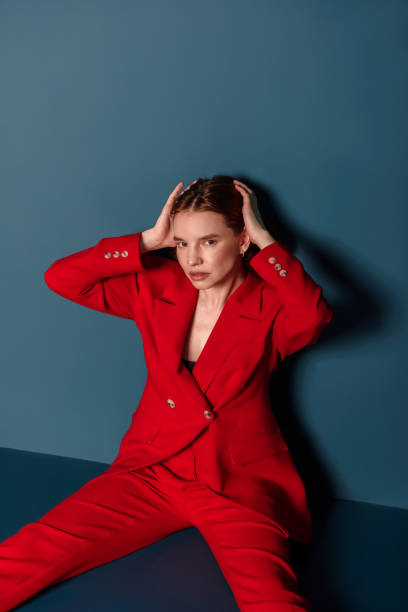 portrait of fashionable woman in red jacket sitting looking at camera. concept fashion - fashion stock pictures, royalty-free photos & images