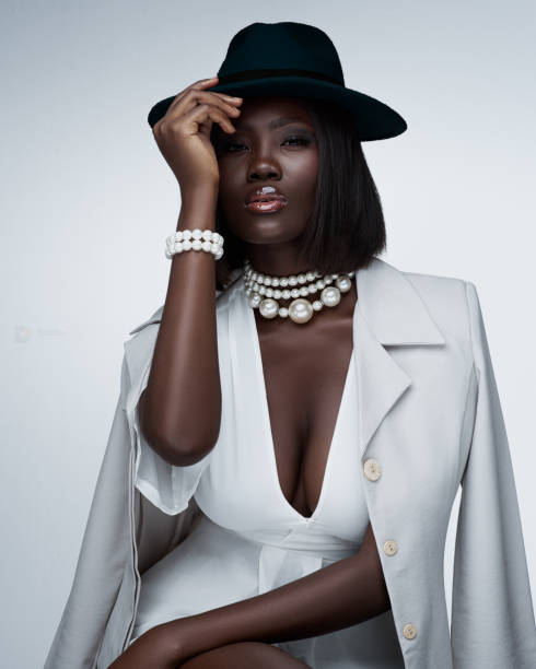 portrait of fashionable young woman wearing black dress and leather jacket - fashion stock pictures, royalty-free photos & images