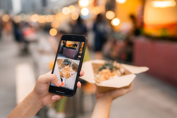 portrait of happy woman enjoying with first time to eat street food - food stock pictures, royalty-free photos & images