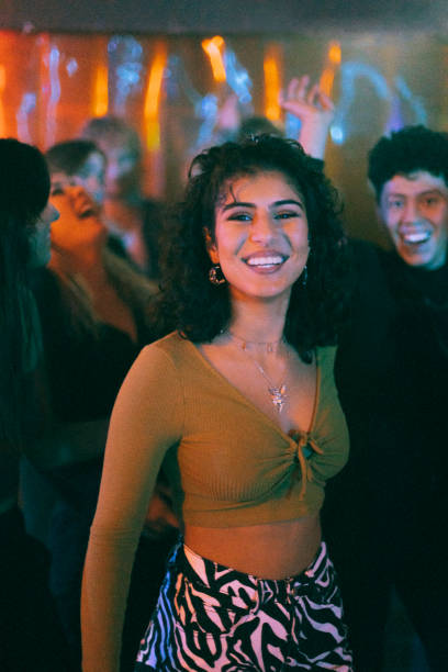 portrait of happy woman with friend dancing in nightclub - concert stock pictures, royalty-free photos & images