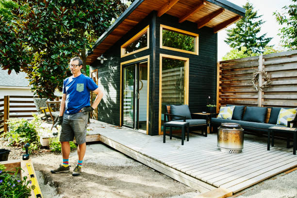 portrait of man building in backyard on summer afternoon - home decoration stock pictures, royalty-free photos & images