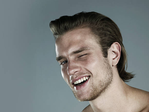 portrait of man winking - hairstyle stockfoto's en -beelden