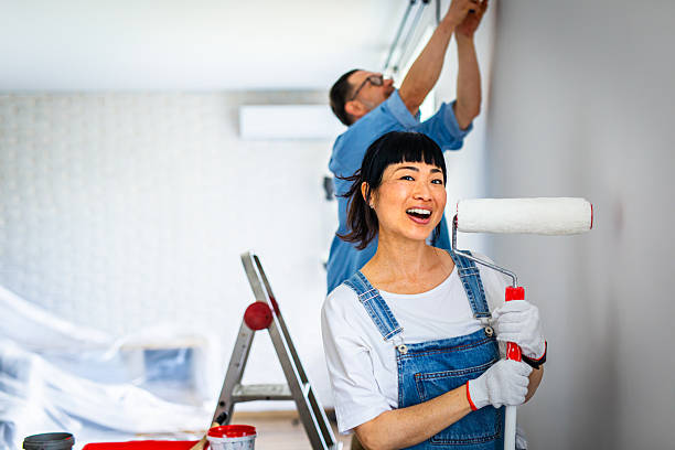 portrait of woman holding paint roller during home renovation - home decoration stock pictures, royalty-free photos & images
