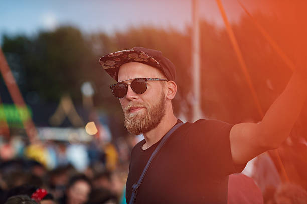 portrait of young man at music festival - concert stock pictures, royalty-free photos & images