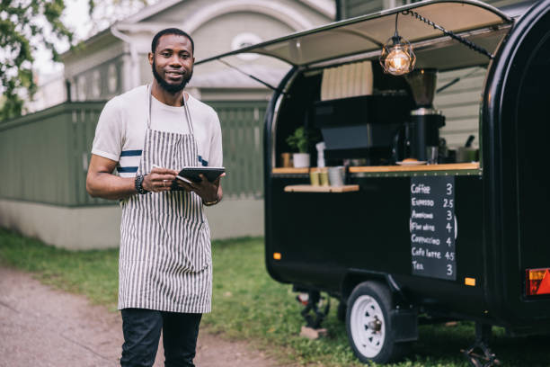 positive african small business owner with his coffee trailer - junk food stock pictures, royalty-free photos & images