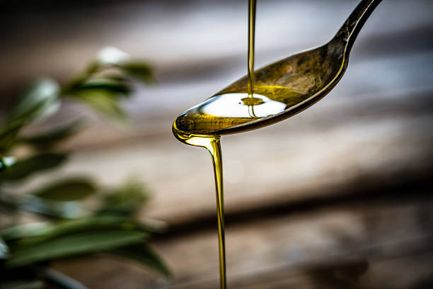 pouring extra virgin olive oil - food stock pictures, royalty-free photos & images