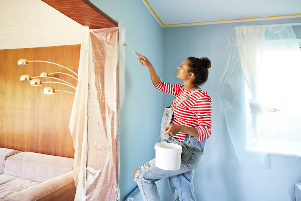 pregnant woman in bib overalls renovating room - home decoration stock pictures, royalty-free photos & images