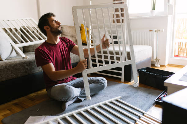 preparing the crib for new family member - home decoration stock pictures, royalty-free photos & images