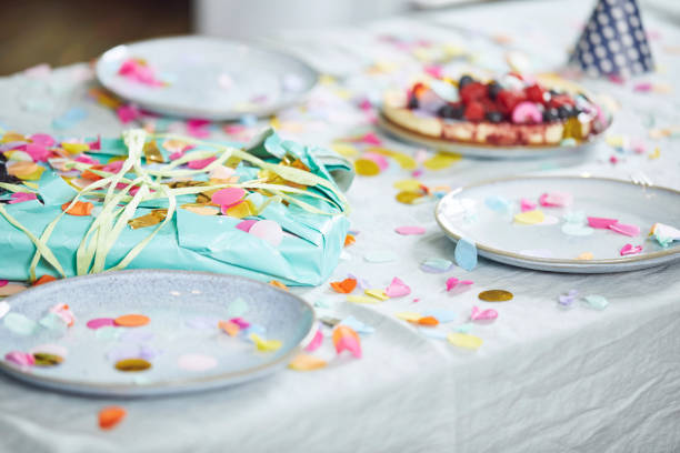 present on table, decorated with confetti - home decoration stock pictures, royalty-free photos & images