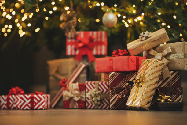 presents and gifts under christmas tree, winter holiday concept - home decoration stock pictures, royalty-free photos & images