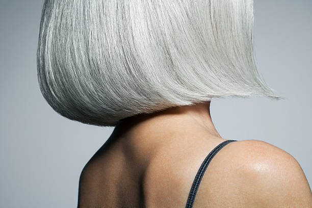 profile of a grey haired woman in a bob, cropped. - hairstyle stock-fotos und bilder