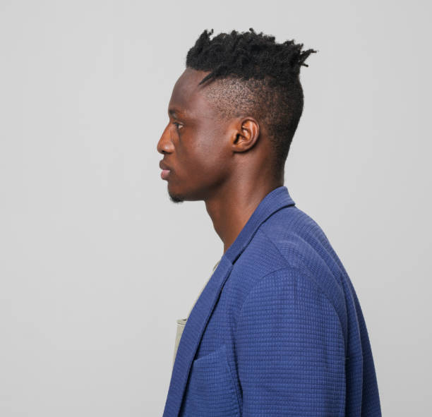 profile of young businessman in blue blazer - hairstyle stock pictures, royalty-free photos & images