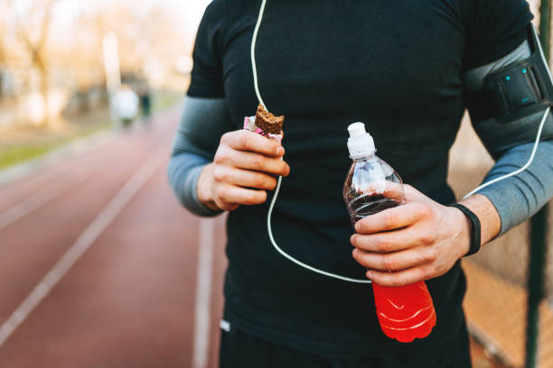 protein bar and energy drink - close up - food stock pictures, royalty-free photos & images