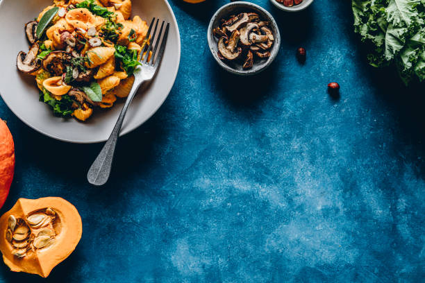pumpkin pasta with mushroom and hazelnuts - food stock pictures, royalty-free photos & images