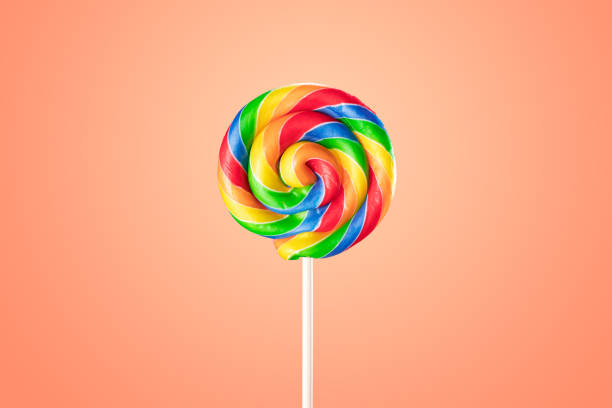 rainbow striped candy lollipop - junk food stock pictures, royalty-free photos & images