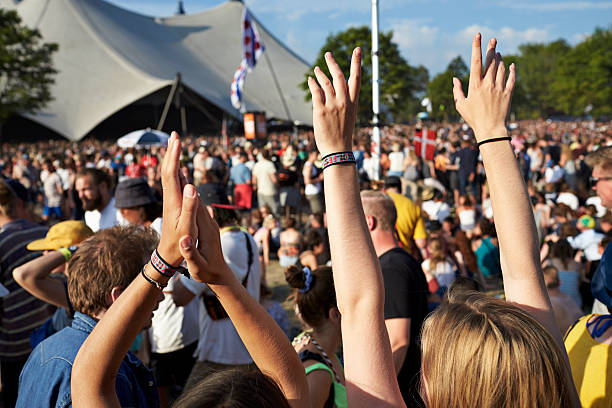 raised clapping hands at concert with big crowd - concert stock pictures, royalty-free photos & images