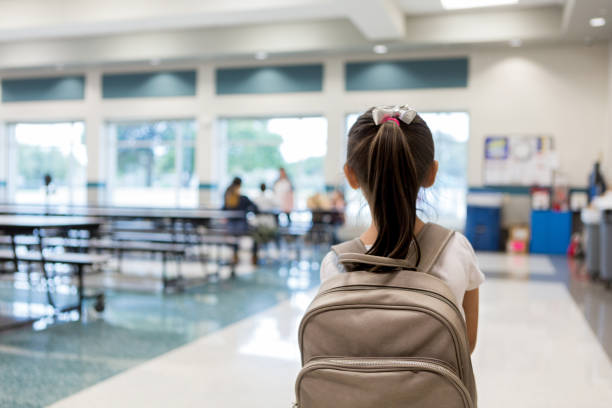 rear view of young schoolgirl entering cafeteria - food stock pictures, royalty-free photos & images