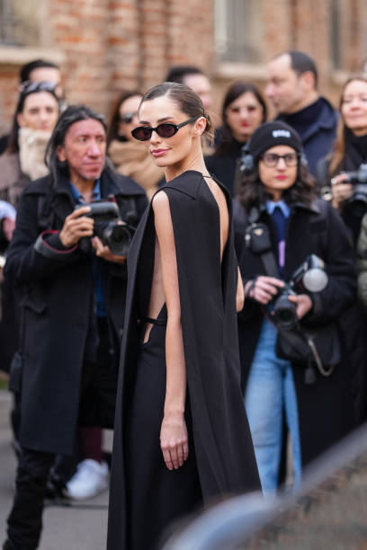 Rebecca Donaldson wears black sunglasses, black sleeveless cutout maxi dress, outside Sportmax, during the Milan Fashion week Women's Fall/Winter...