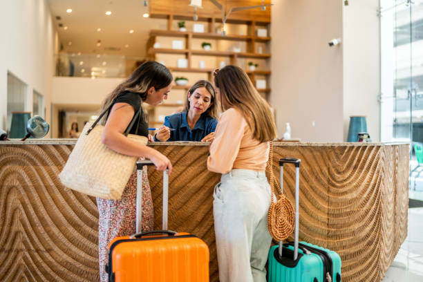 receptionist talking customers at hotel lobby - travel stock pictures, royalty-free photos & images