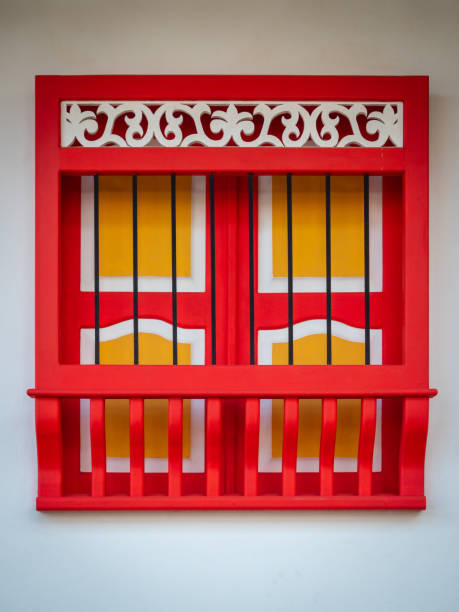 red and yellow window forming a cross in a white background, characteristic of the town of jerico, antioquia, colombia - garden decoration stock pictures, royalty-free photos & images