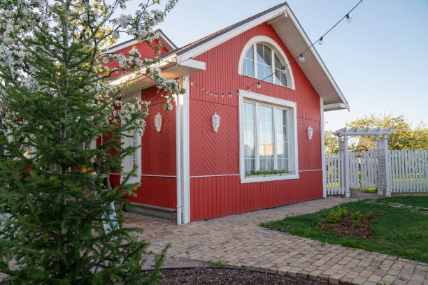 red house with string lights by trees in back yard - garden decoration stock pictures, royalty-free photos & images