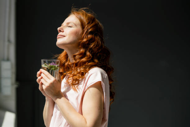 redheaded woman enjoying sunlight - food stock pictures, royalty-free photos & images