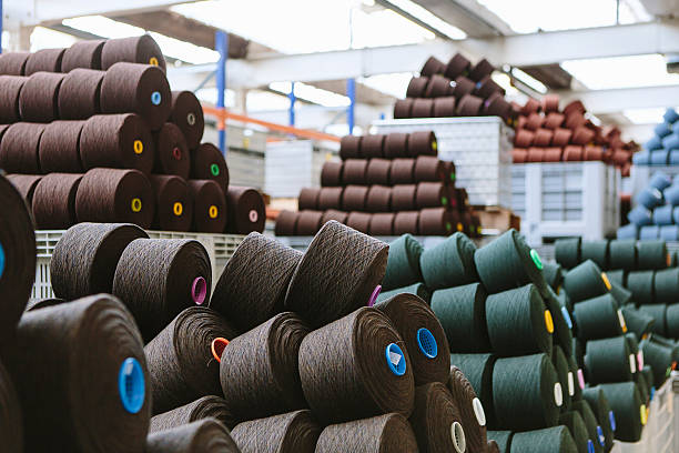 reels of wool in storage room in woollen mill - fashion stock pictures, royalty-free photos & images
