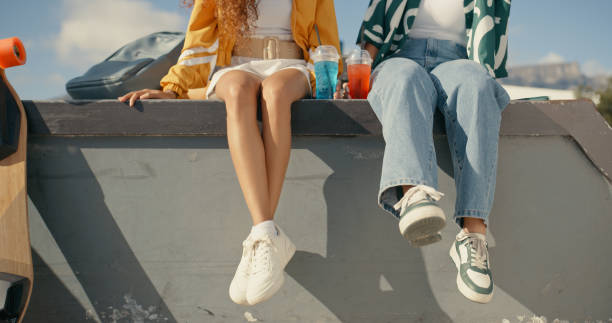 relax, shoes and summer with friends at skate park for bonding, calm and hipster. cheers, mockup and teenager with closeup of people in outdoors for skating, fitness and sports training together - fashion stock pictures, roya