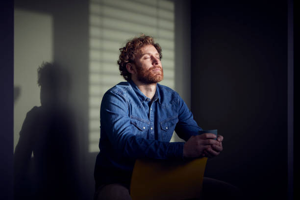relaxed casual businessman sitting down with closed eyes - coffee stockfoto's en -beelden