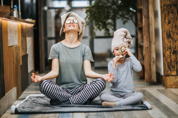 relaxed mother and daughter exercising yoga in the morning at home. - food stock pictures, royalty-free photos & images