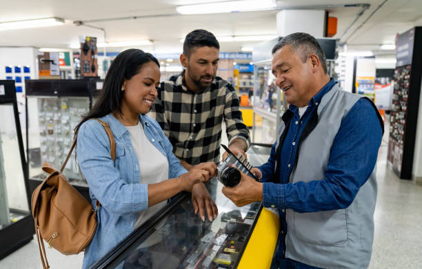 retail clerk helping a couple shopping at a hardware store - home decoration stock pictures, royalty-free photos & images