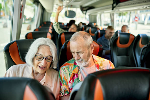 retired tourists in 60s and 70s onboard motor coach - travel stock pictures, royalty-free photos & images