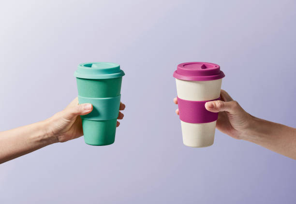 reusable coffee cup in hand - junk food stock pictures, royalty-free photos & images