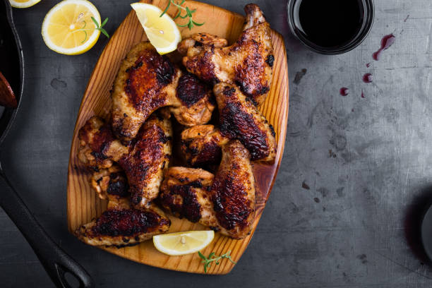roast chicken wings on cutting board - junk food stock pictures, royalty-free photos & images