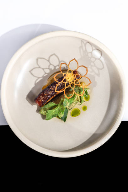 roast pork belly meat dish with sage butter and dill oil at michelin star gourmet restaurant - food stock pictures, royalty-free photos & images
