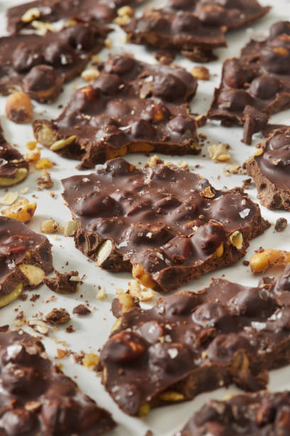 roasted chick pea and pumpkin seed chocolate bark - junk food stock pictures, royalty-free photos & images