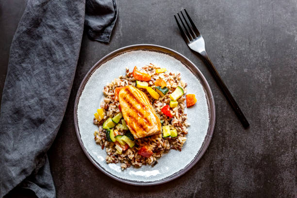 roasted salmon with wild rice and vegetables - food stock pictures, royalty-free photos & images