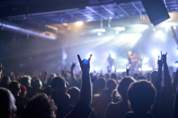 rock band performer cheering up the crowd at music festival - concert stock pictures, royalty-free photos & images