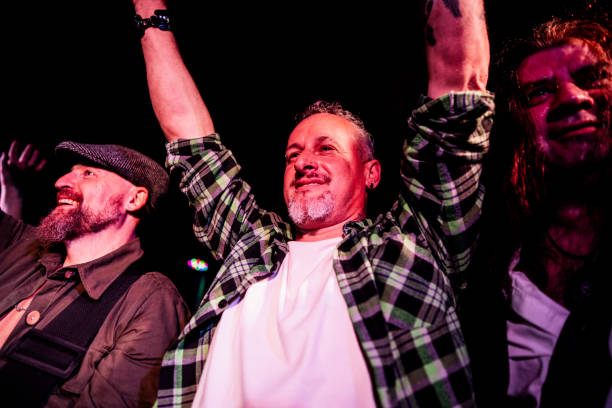 rock band performing and thanking audience on nightclub - concert stock pictures, royalty-free photos & images